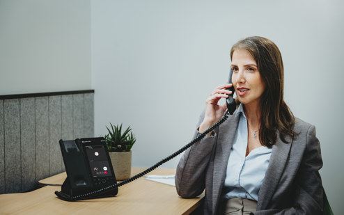 A Woman Using an AudioCodes C470HD IP Phone 5