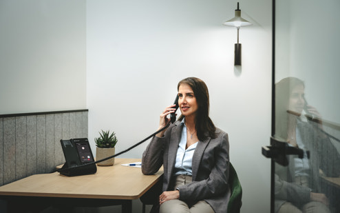 A Woman Using an AudioCodes C470HD IP Phone 2