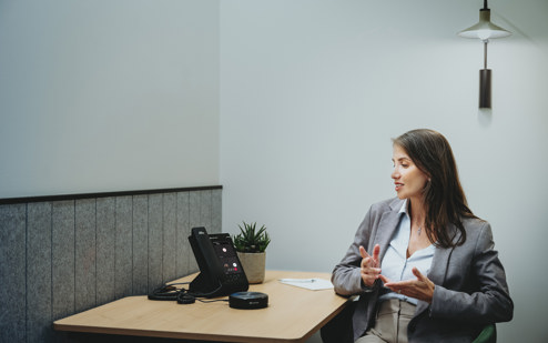 A Woman Using an AudioCodes C470HD IP Phone