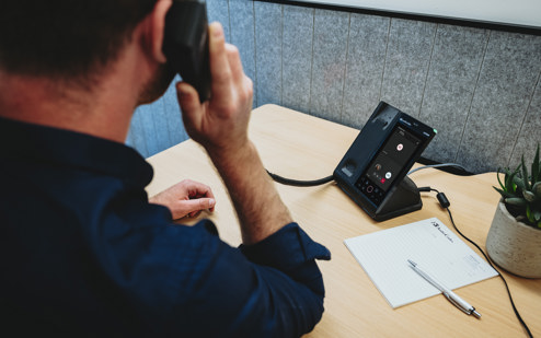 A Man Using an AudioCodes C470HD IP Phone 7