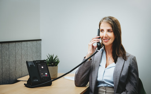 A Woman Using an AudioCodes C470HD IP Phone 3