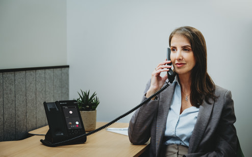 A Woman Using an AudioCodes C470HD IP Phone 4