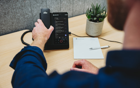 A Man Using an AudioCodes C470HD IP Phone 6